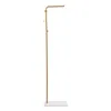 A gold coat rack with a white base on a white background. Náhled obrázku produktu