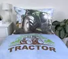 A close-up view of a tractor-themed duvet cover and pillowcase set on a bed. Náhled obrázku produktu