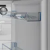 Close-up of the inside of a refrigerator, showing an egg tray. Voir les images du produit