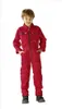 A young boy is standing and posing in a red jumpsuit. Produktbild-Vorschau