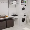 A laundry room with a washing machine, dryer, sink, and storage baskets. Anteprima dell’immagine prodotto