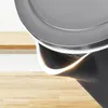 Close-up of the top part of a black electric kettle with a silver lid, resting on a wooden surface. Anteprima dell’immagine prodotto