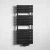 A black radiator is mounted on a white wall. Produktbild-Vorschau