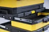 A close-up view of a yellow and black tool chest with open drawers and metal drawer slides. Voir les images du produit