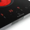 A close-up view of a modern vitroceramic cooktop with illuminated digital controls and a heating element glowing red. Produktbild-Vorschau