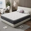 A bedroom scene with a mattress on a bed frame, pillows, and a chair. Produktbild-Vorschau