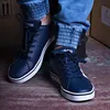 A person wearing blue jeans and dark blue Adidas sneakers. Náhľad obrázku produktu