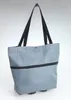 A gray shopping trolley bag with black handles and a black zipper is shown against a light gray background. Náhľad obrázku produktu