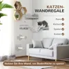 A cat climbing on a wall-mounted cat tree in a living room setting with a sofa. Podgląd zdjęcia produktu