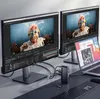 A desk setup with two monitors displaying video editing software, a laptop, a keyboard, a mouse, and a docking station. Produktbild-Vorschau
