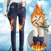 Dunkelblaue, mit Fleece gefütterte Denim-Jeans mit Schneeflocken-Motiven, an einer Person getragen, mit digital hinzugefügten Flammen, um Wärme zu zeigen Produktbild-Vorschau