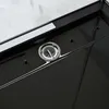 A close-up view of a black shower tray with a silver drain. Produktbild-Vorschau
