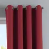 A close-up view of a red curtain hanging from a curtain rod. Produktbild-Vorschau