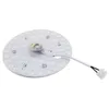 A circular LED light module with a white base and multiple small LED lights arranged in concentric circles. A small central component with wires is visible. A white cable with blue and brown wires extends from the module to a white connector. Produktbild-Vorschau
