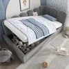 A child's bed with storage, showing stuffed animals inside the storage compartment. Produktbild-Vorschau