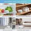 A collage showing a portable air purifier being used in different household locations: a refrigerator, a shoe cabinet, a closet, and a pet area. Produktbild-Vorschau