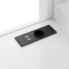 A black charging station with two USB ports and a circular opening is mounted on a white surface, likely a desk or shelf. Produktbild-Vorschau