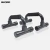 A pair of black push-up handles with black foam grips, shown from a diagonal angle against a light gray and white background. Produktbild-Vorschau