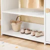 A close-up view of a white shelf with a woven basket and children's shoes. Anteprima dell’immagine prodotto