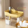 A cat is sleeping next to a pet water fountain that is dispensing water. Produktbild-Vorschau