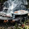 Cooking breakfast outdoors over a campfire. Produktbild-Vorschau