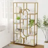 A gold and white geometric bookshelf filled with decorative items and books, placed in a well-lit room with a sofa and curtains visible. Podgląd zdjęcia produktu