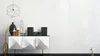 A modern living room setup with a minimalist sideboard and decorative items. Produktbild-Vorschau