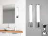 A split image showing a bathroom vanity with a mirror and sink on the left, and two wall lights with an electrical outlet on the right. Produktbild-Vorschau