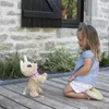 A young girl kneels on a wooden deck, looking at a stuffed toy dog. Anteprima dell’immagine prodotto