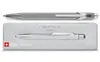 A silver Caran d'Ache 849 Original ballpoint pen is shown above its matching metal case. Náhled obrázku produktu