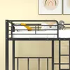 A close-up view of the top bunk of a black metal bunk bed, with bedding, pillows, and a teddy bear. Náhled obrázku produktu