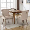 A dining room scene with a wooden table and two beige upholstered chairs. Podgląd zdjęcia produktu