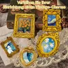 A collection of small, ornate, gold-colored picture frames with miniature paintings inside, arranged on a lace tablecloth. Produktbild-Vorschau