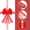 A collage showing a red tulle bow with a silver embellishment, and three inset images demonstrating how to handle and shape the tulle. Náhled obrázku produktu