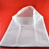 A white mesh bag is laid out on a red surface. Produktbild-Vorschau