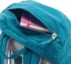 Close-up of a teal backpack with a pink notebook inside an open zippered pocket. Produktbild-Vorschau