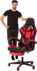 A man stands next to a gaming chair.