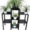 A dark wooden plant stand with several potted plants on it, set against a white background. Anteprima dell’immagine prodotto
