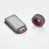 Two parts of a vacuum cleaner are displayed against a light gray and white gradient background. On the left is a rectangular filter or dustbin with a red latch. On the right is a cylindrical brush roll with red accents. Produktbild-Vorschau