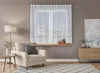 A living room scene with a chair, lamp, and curtains. Náhled obrázku produktu
