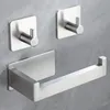 A set of brushed stainless steel bathroom accessories, including a toilet paper holder and two hooks, mounted on a gray textured wall. Produktbild-Vorschau