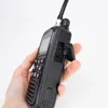 A hand holding a black CB radio. Voir les images du produit