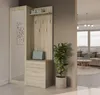 A hallway or entryway with a furniture piece featuring a mirror, shelves, and drawers, next to a potted plant. The background shows a living room area with a sofa and a large window. Produktbild-Vorschau
