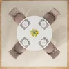 A top-down view of a round dining table set for four, with chairs around it, placed on a rug. Náhľad obrázku produktu