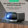 A BlitzWolf BW-V9 projector is shown on a wooden surface with text overlays describing its features. Produktbild-Vorschau