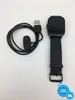 A black smartwatch and its charging cable are laid out on a white background. Voir les images du produit
