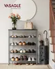 An entryway with a shoe rack, vase of flowers, handbag, and umbrella stand. Produktbild-Vorschau