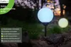 Two solar garden lights in a garden setting at dusk. Produktbild-Vorschau
