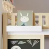 A close-up view of a child's loft bed with a chalkboard and a framed picture of a bunny. Náhled obrázku produktu
