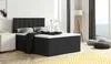 A bedroom scene with a bed, nightstand, lamp, and floor cushions.